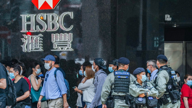Riot police stand guard in front of an HSBC branch in Hong Kong's Central district on Friday. 