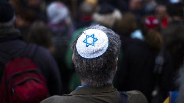 A man wears a Jewish skullcap as he attends a demonstration against an anti-Semitic attack  in Berlin in April.