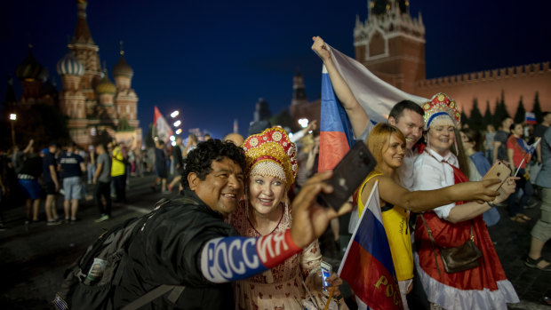 Fans take selfies in the Red Square after Russia defeated Spain