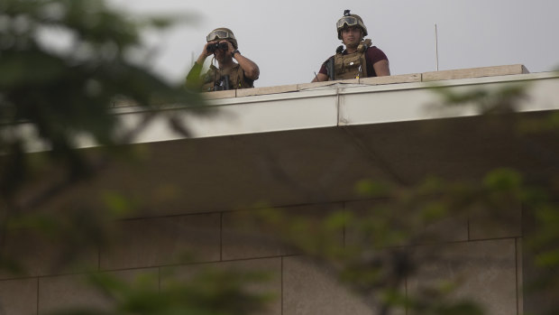 US soldiers stand guard on the rooftop of the US Embassy.