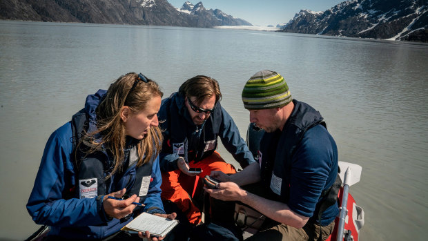 Mette Bendixen, David Blockley and Mikkel Bojesen collect sediment samples a few miles up the Sermilik Fjord in southwestern Greenland.
