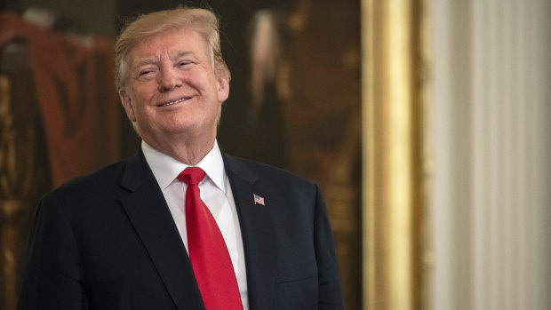 US President Donald Trump smiles at a White House event shortly after the release of the redacted Mueller report. 