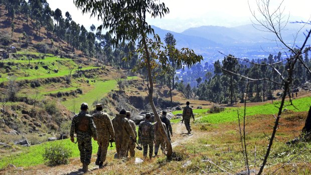 Pakistani soldiers patrol in the area where Indian planes were reportedly shot down by Pakistani forces.