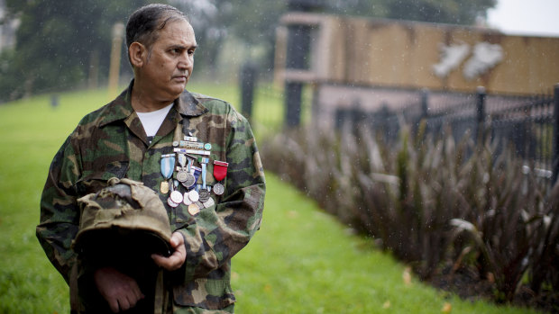 Argentine war veteran Jorge Altieri with the blood-stained helmet that saved his life in 1982.