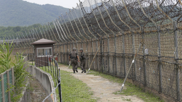 South Korean army soldiers patrol while hikers visit the DMZ Peace Trail in the demilitarised zone in Goseong, South Korea.