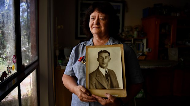 Kerry Fowler-Smith at home in Gosford holding a portrait of her great-uncle Sid.
