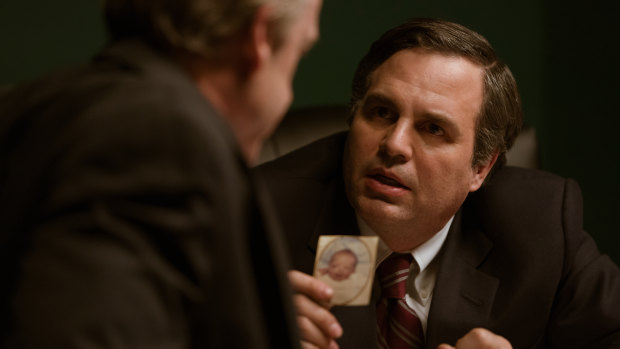 Mark Ruffalo holds a photograph of a child born with deformities in Dark Waters.