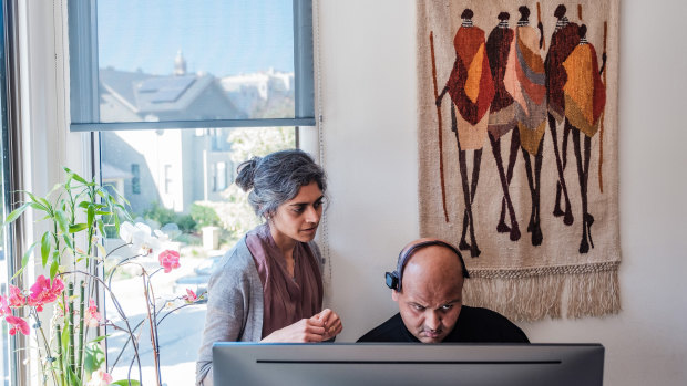 Rahul Desikan, with his wife Maya Vijayaraghavan, communicates using eye movement to type on his computer. 