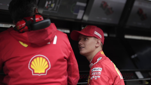 Schumacher talks to a Ferrari team member during his first F1 test.