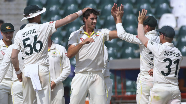 Australian captain Pat Cummins celebrates a Pakistan wicket with teammates on the final day of the third Test.