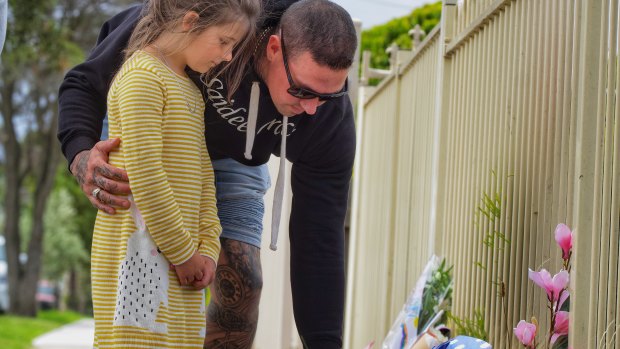 Sienna Stephens and her father Mark from Lancefield, leave flowers.