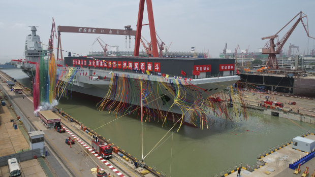The Fujian, seen here at its launch, can dispatch planes deep into Pacific territory. 