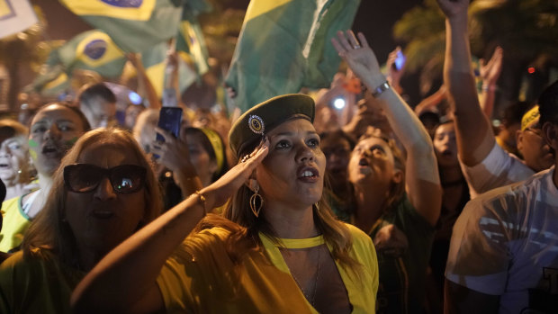 Supporters of Jair Bolsonaro celebrate in front of his residence in Rio.