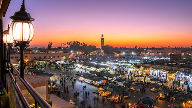 Bustling Jemaa el-Fnaa square at sunset in Marrakesh, Morocco.