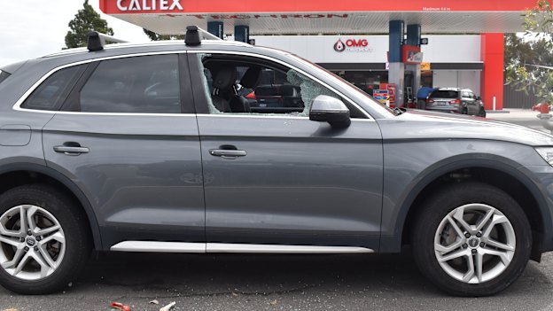 A car with a smashed window at the local shopping centre.
