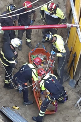 Italian firefighters rescuing a man who was trapped in a tunnel in Rome.