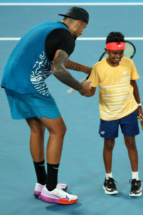 Nick Kyrgios and playing partner celebrate a point.