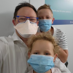 Infectious disease physician Paul Griffin takes a selfie with children Max, 11, and Chloe, 6, as they have their COVID vaccinations.