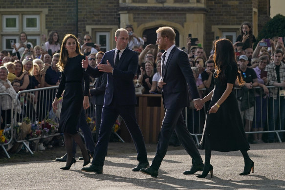 Prince William and Kate, Princess of Wales, and Prince Harry and Meghan, Duchess of Sussex walk to greet the crowds after viewing the floral tributes for the late Queen Elizabeth II outside Windsor Castle.