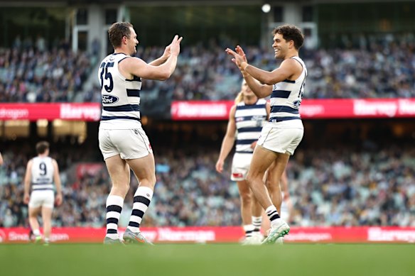 Patrick Dangerfield of the Cats celebrates a goal with Jack Martin.
