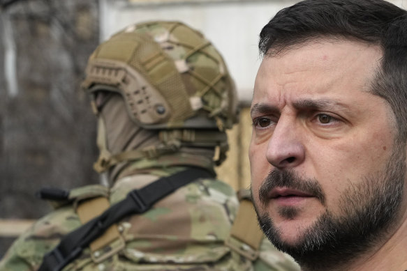 Ukrainian President Volodymyr Zelensky visits a missile-damaged area in Zaporizhzhia, Ukraine, last month.