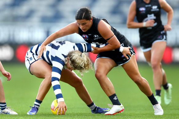 Georgie Prespakis of the Cats and Madison Prespakis of the Blues compete for the ball.