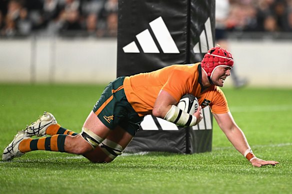 Harry Wilson dives under the posts to score for the Wallabies.
