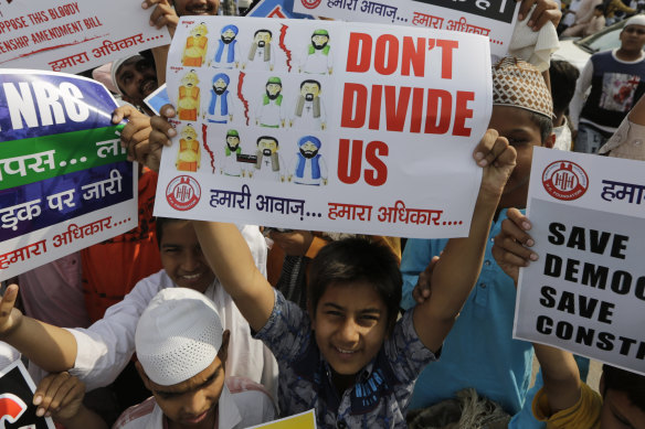An Indian Muslim boy holds a placard during a protest against the Citizenship Amendment Bill.