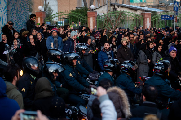 Police intervene during a vigil in Tehran in honour of the victims of a Ukraine International Airlines flight shot down in Iran.