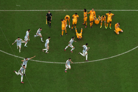 Argentina players celebrate in front of their beaten opponents after the winning penalty.