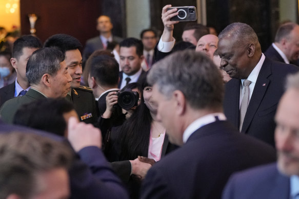 US Defence Secretary Lloyd Austin (right) shakes hands with China’s Defence Minister, Li Shangfu, on Friday night. 