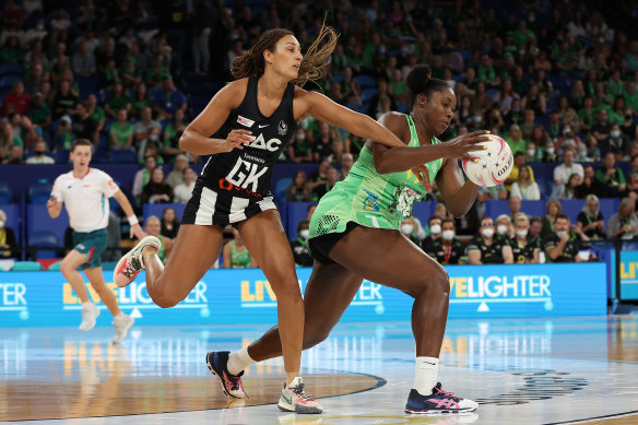 Goal-keeper Geva Mentor (left) stretches to defend against Jhaniele Fowler (right).