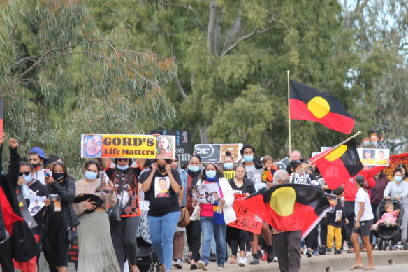 The crowd walks through the streets of Moree. 