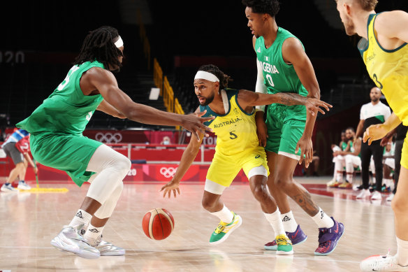 Patty Mills looks to find some space as the Nigerians close him down.