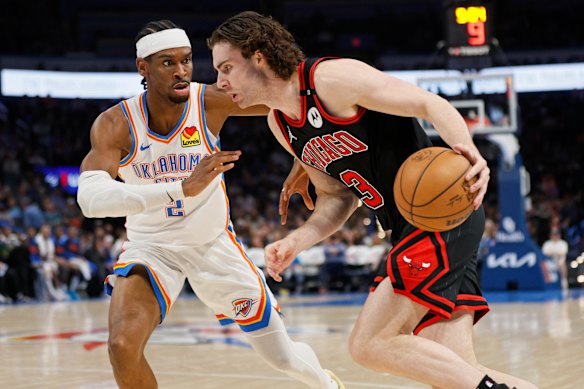 Giddey drives against Oklahoma City Thunder superstar, and former teammate, Shai Gilgeous-Alexander.
