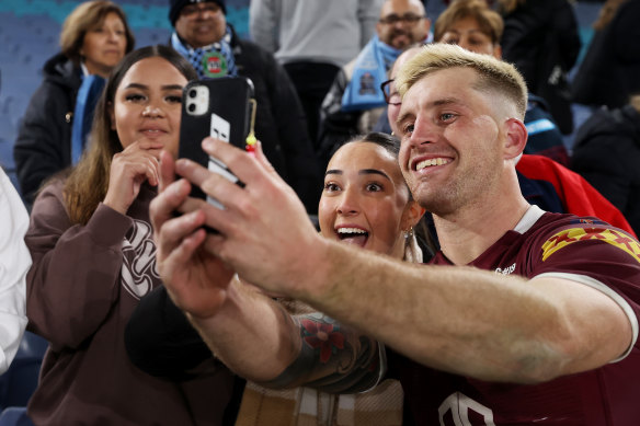 Cameron Munster takes a selfie with a fan after the Maroons won game one.