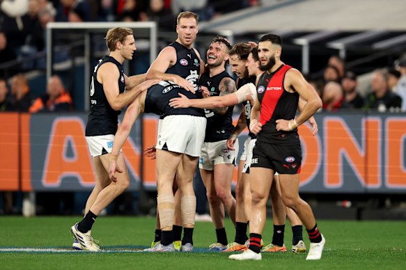Francis Evans of the Blues is congratulated by team mates after kicking a goal.