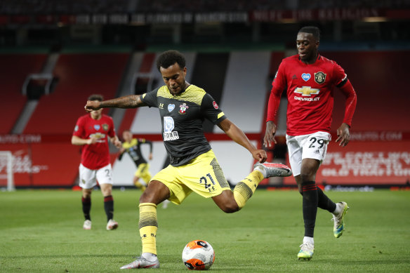 Ryan Bertrand of Southampton shoots under pressure from Aaron Wan-Bissaka of Manchester United during the Premier League match between Manchester United and Southampton FC at Old Trafford.