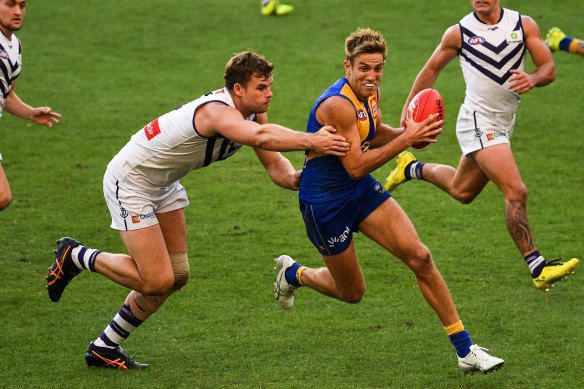 Brad Sheppard is tackled by Sean Darcy of the Dockers.