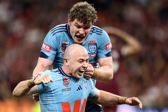 Liam Martin celebrates with Dylan Edwards after the fullback’s late try all but sealed victory for NSW.