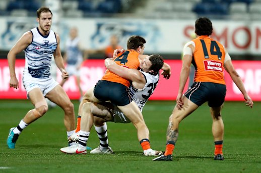 Toby Greene tries to fend off Patrick Dangerfield.