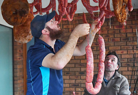 Steven Napoli hangs the salami with his father Frank.