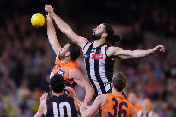 More appreciation required: Magpie Brodie Grundy reaches over Shane Mumford.