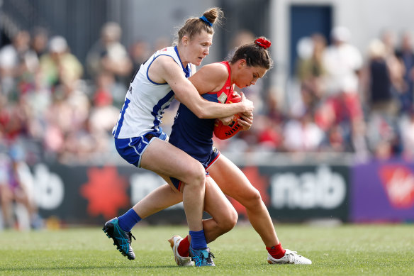 Libby Birch of the Demons is tackled by Tahlia Randall of the Kangaroos in the qualifying final.