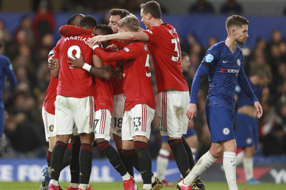 United players congratulate Anthony Martial after scoring his team's first goal.