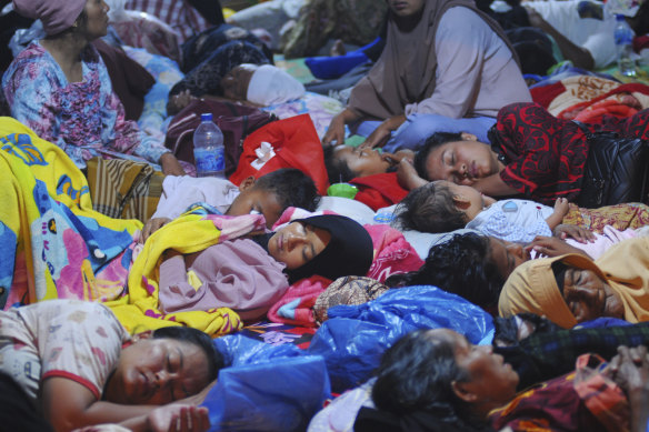 Earthquake survivors sleep inside a tent at a temporary shelter in Pasaman Barat, West Sumatra, Indonesia, early on Saturday.