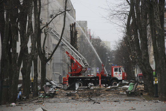 Firefighters extinguish a building after a rocket attack in Kharkiv.