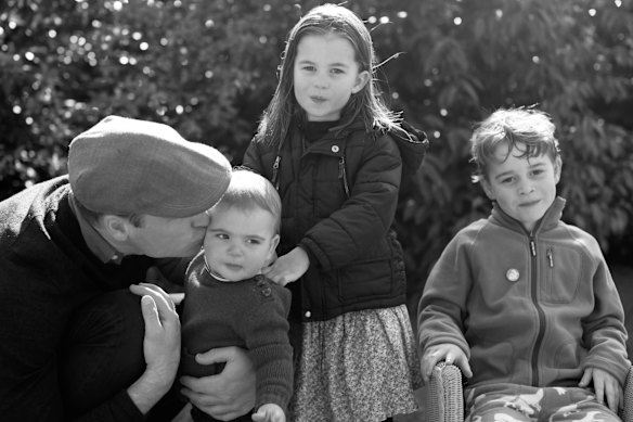 In this 2019 family photo by Catherine, Prince William kisses Prince Louis as they pose next to Princess Charlotte and Prince George in Norfolk. 