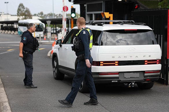Police and security escort families into a Melbourne Jewish school on Monday.