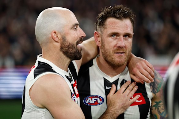 Tim Membrey (right) was consoled by Steele Sidebottom, who was playing his 375th and final AFL game.